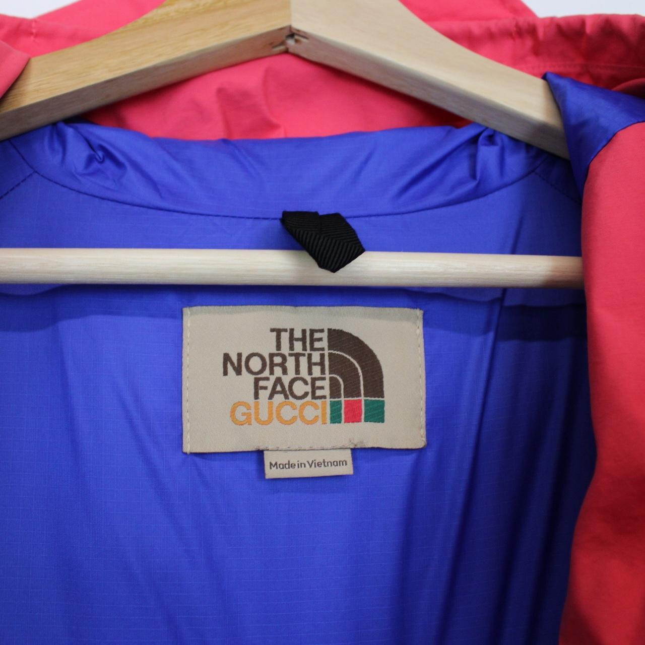Gucci pink windbreaker jacket with North Face logo and full zip design.