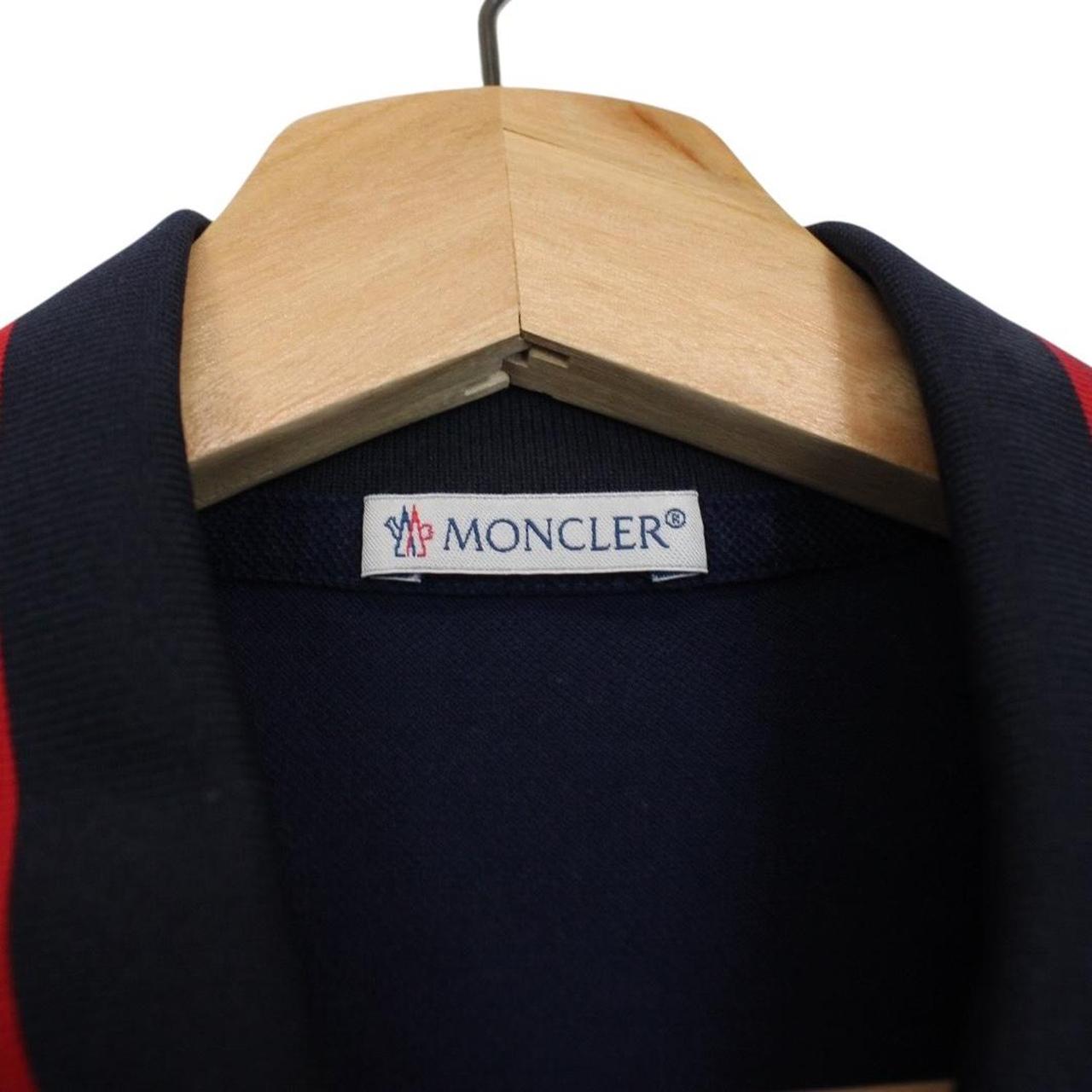 Moncler navy blue short sleeve polo shirt with embroidered logo and cotton material.