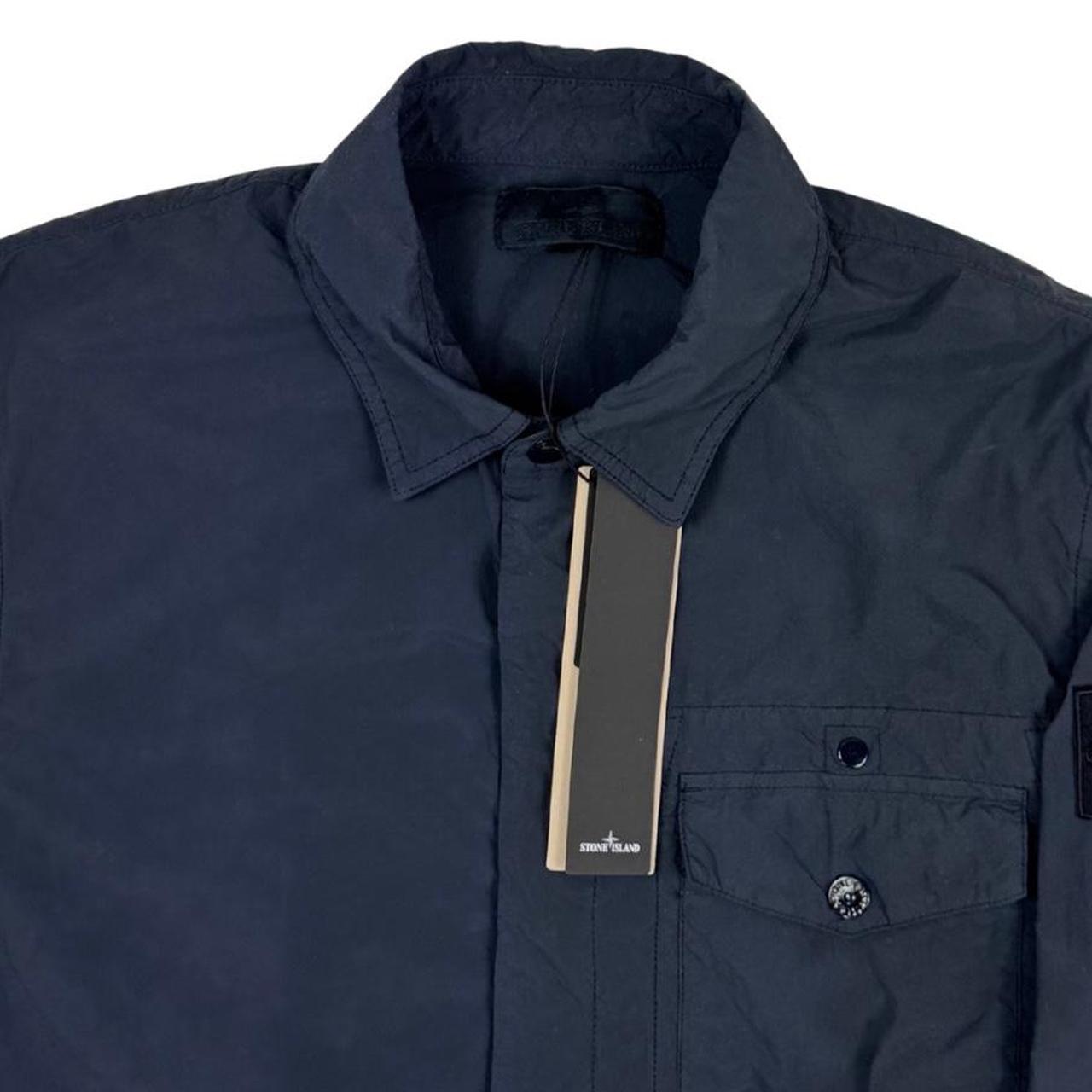 Stone Island navy blue nylon overshirt jacket with ghost logo and smooth texture.