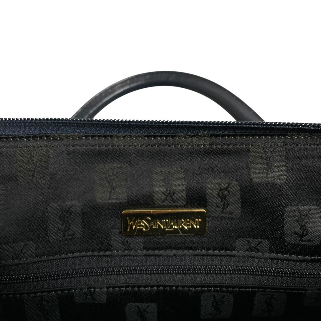 Yves Saint Laurent navy blue duffel bag embossed logo nylon material with handles.