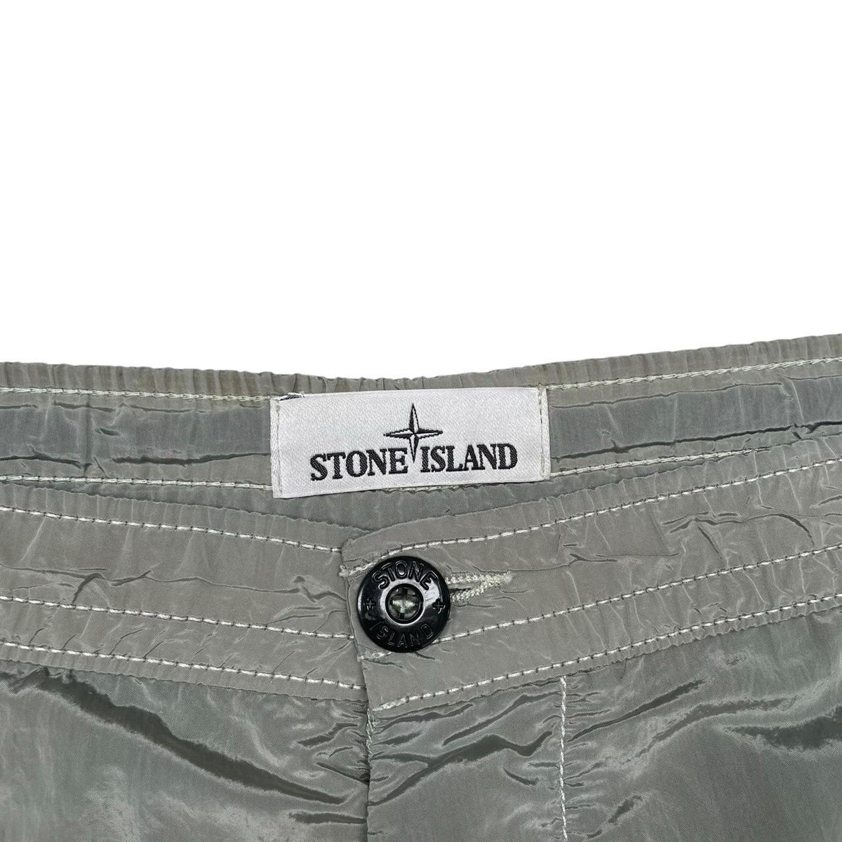 Stone Island green swim shorts with logo patch and nylon metal material.