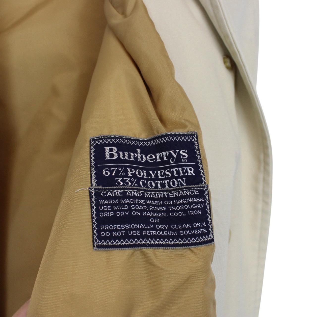 Burberry cream trench coat, single breasted, vintage 80s style, visible mark on sleeve.