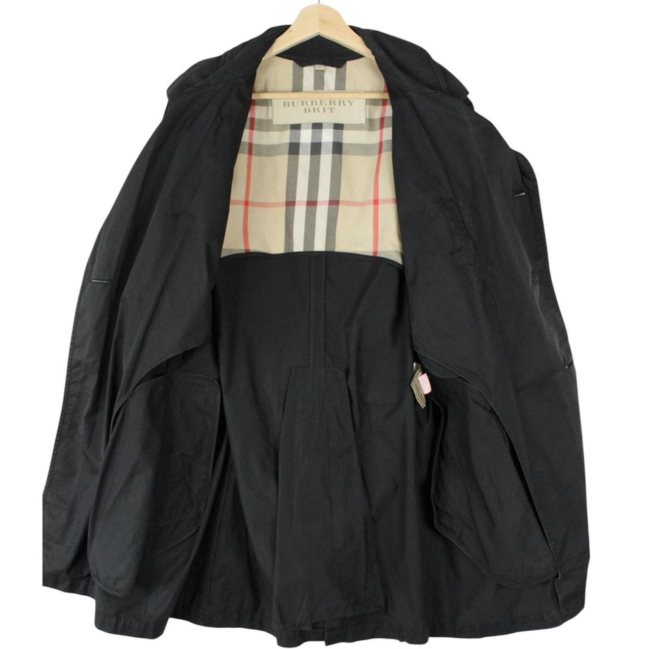 Burberry black trench coat featuring Nova Check pattern, double-breasted design, and belted waist.