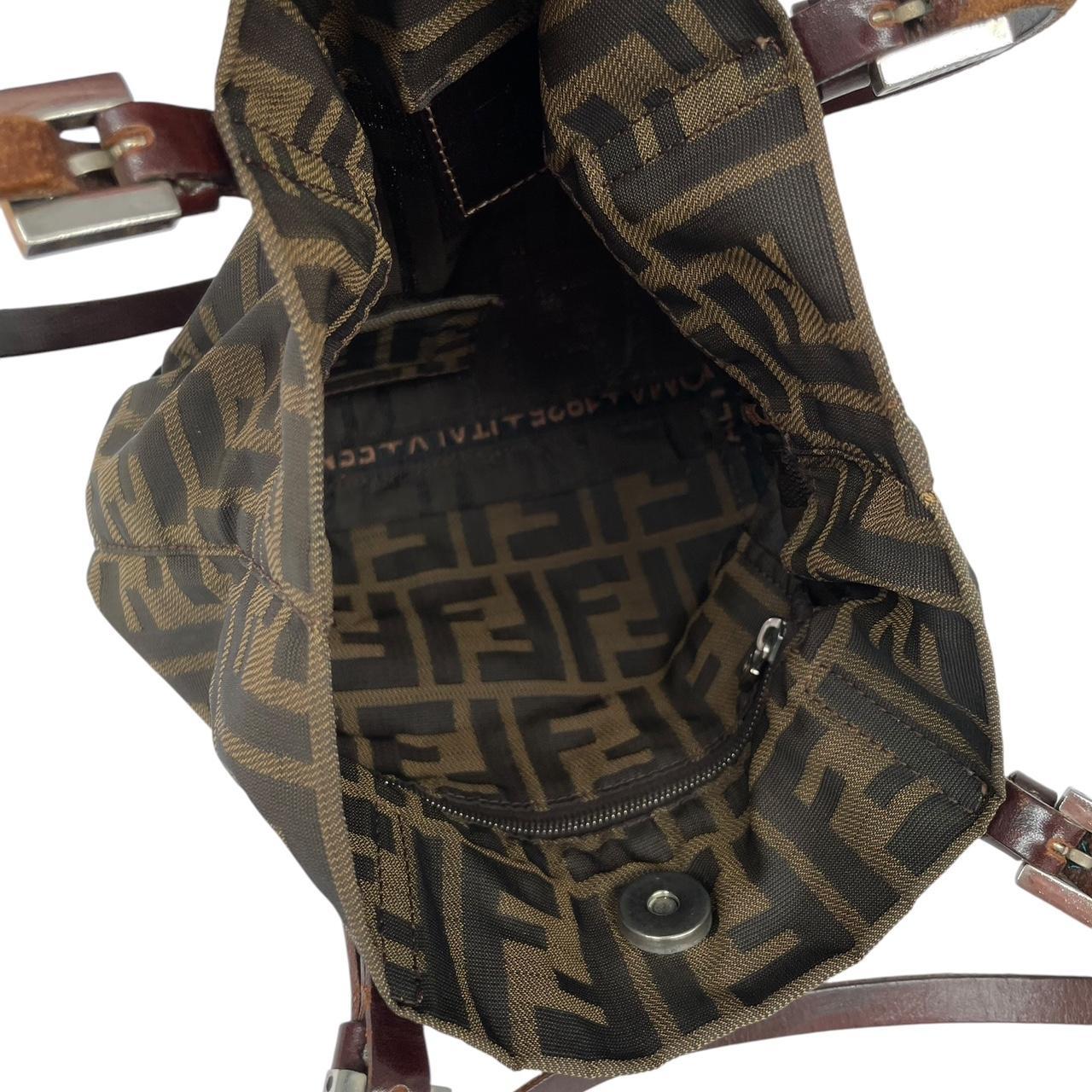 Fendi brown duffel bag featuring iconic Zucca monogram canvas and durable handles.