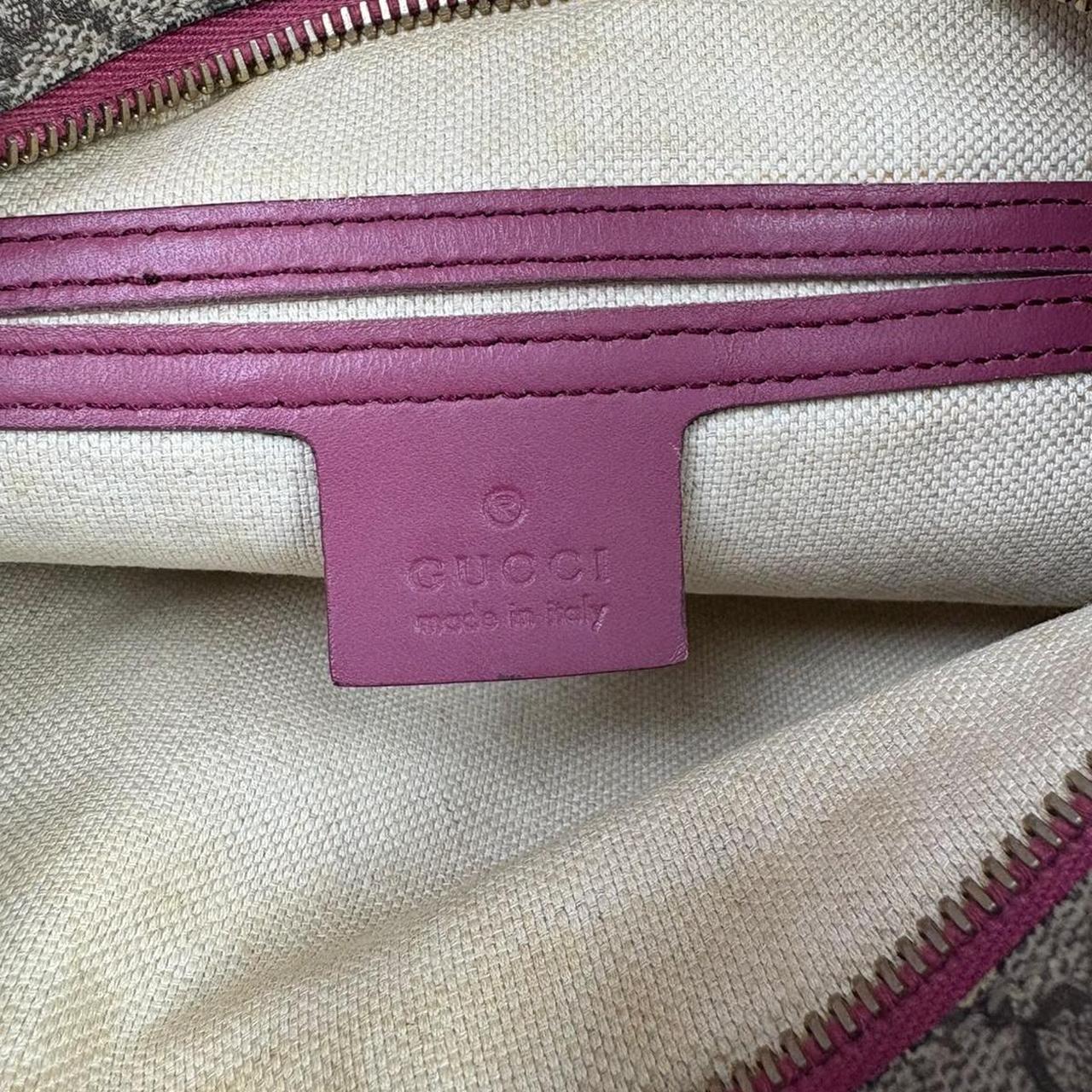 Gucci beige and pink duffel bag with GG Supreme monogram canvas pattern.