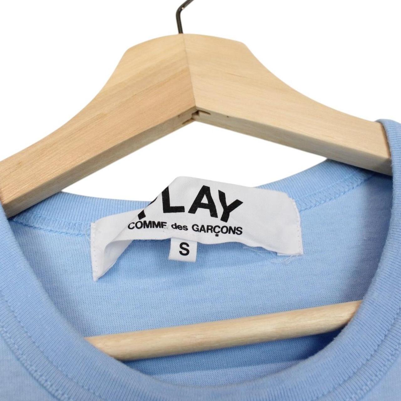 Comme des Garcons light blue short sleeve cotton t-shirt with heart logo and pocket.