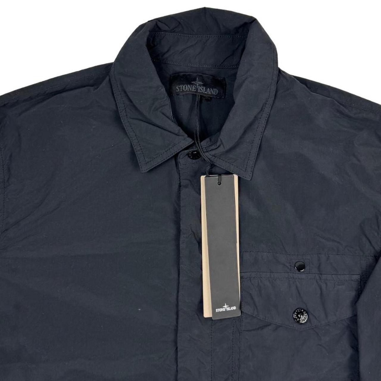 Stone Island black nylon overshirt jacket with ghost logo and smooth texture.