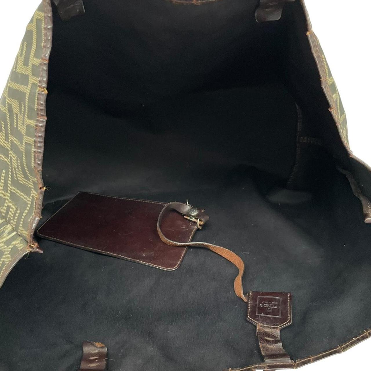 Fendi brown monogram canvas duffel bag with leather trim and logo detail.