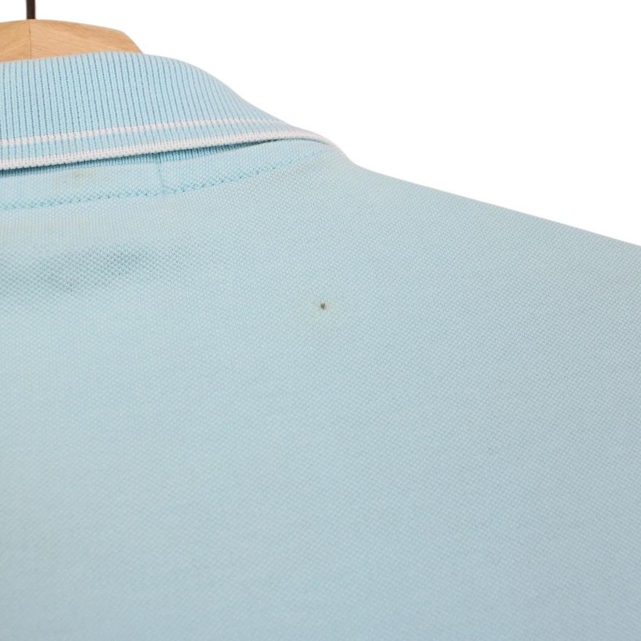 Stone Island blue polo shirt with embroidered compass logo and slim fit cotton material.