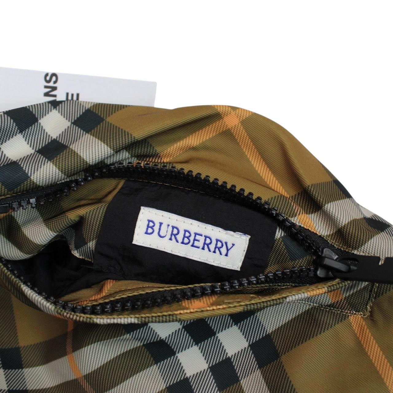 Burberry reversible nylon jacket in brown and black Nova Check pattern with logo.