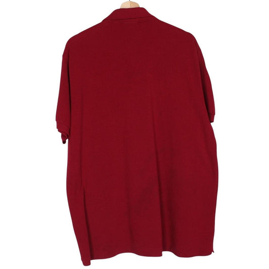 Lacoste burgundy polo shirt with embroidered crocodile logo and pocket detail.