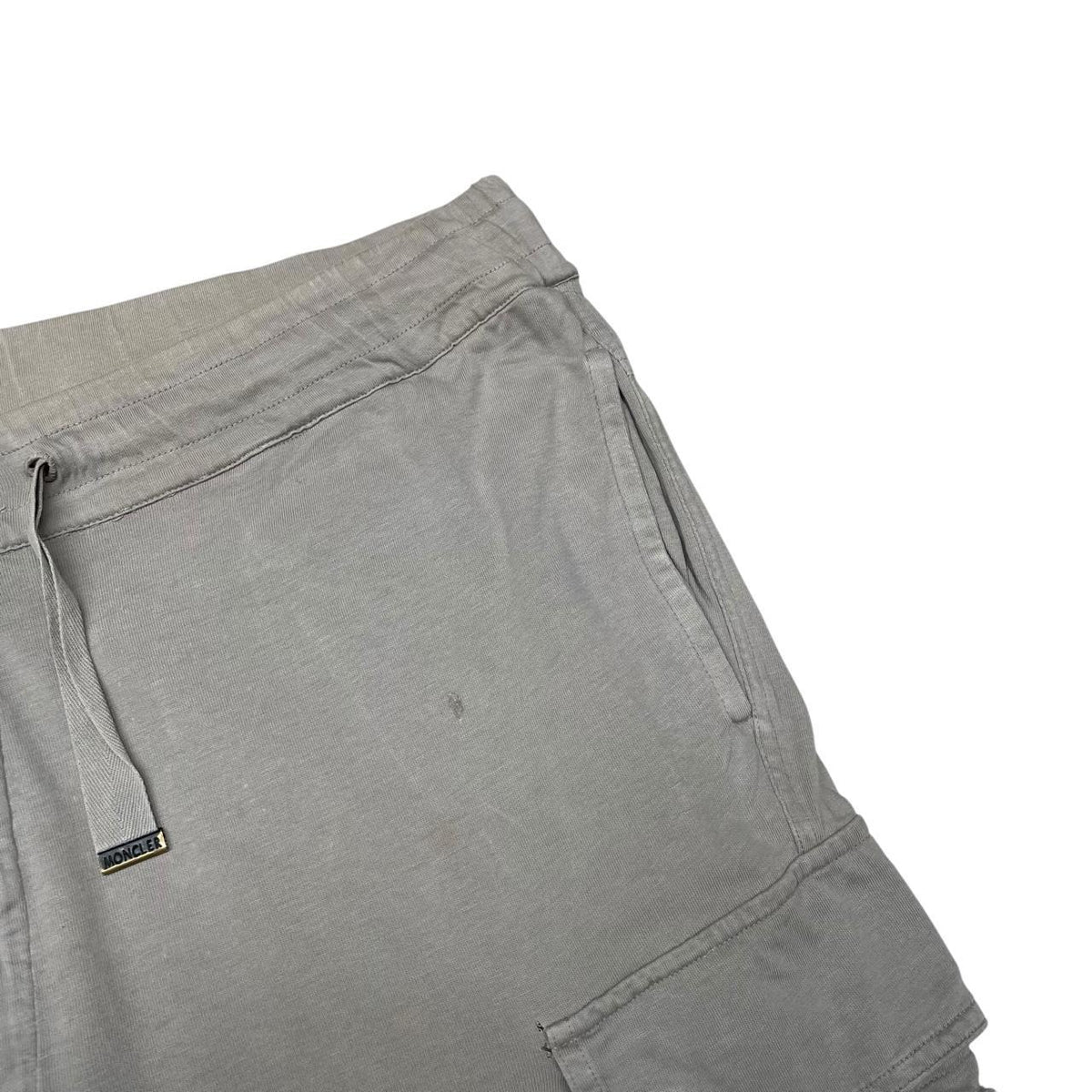 Moncler grey jogger shorts cotton material with logo detail and minor marks.
