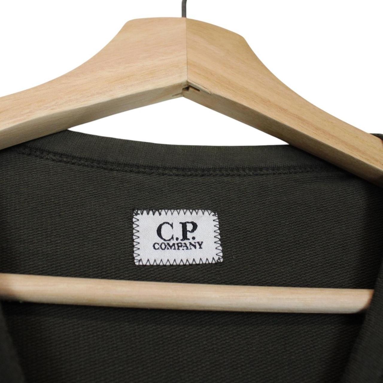 CP Company khaki green sweatshirt with goggle lens detail and cotton material.