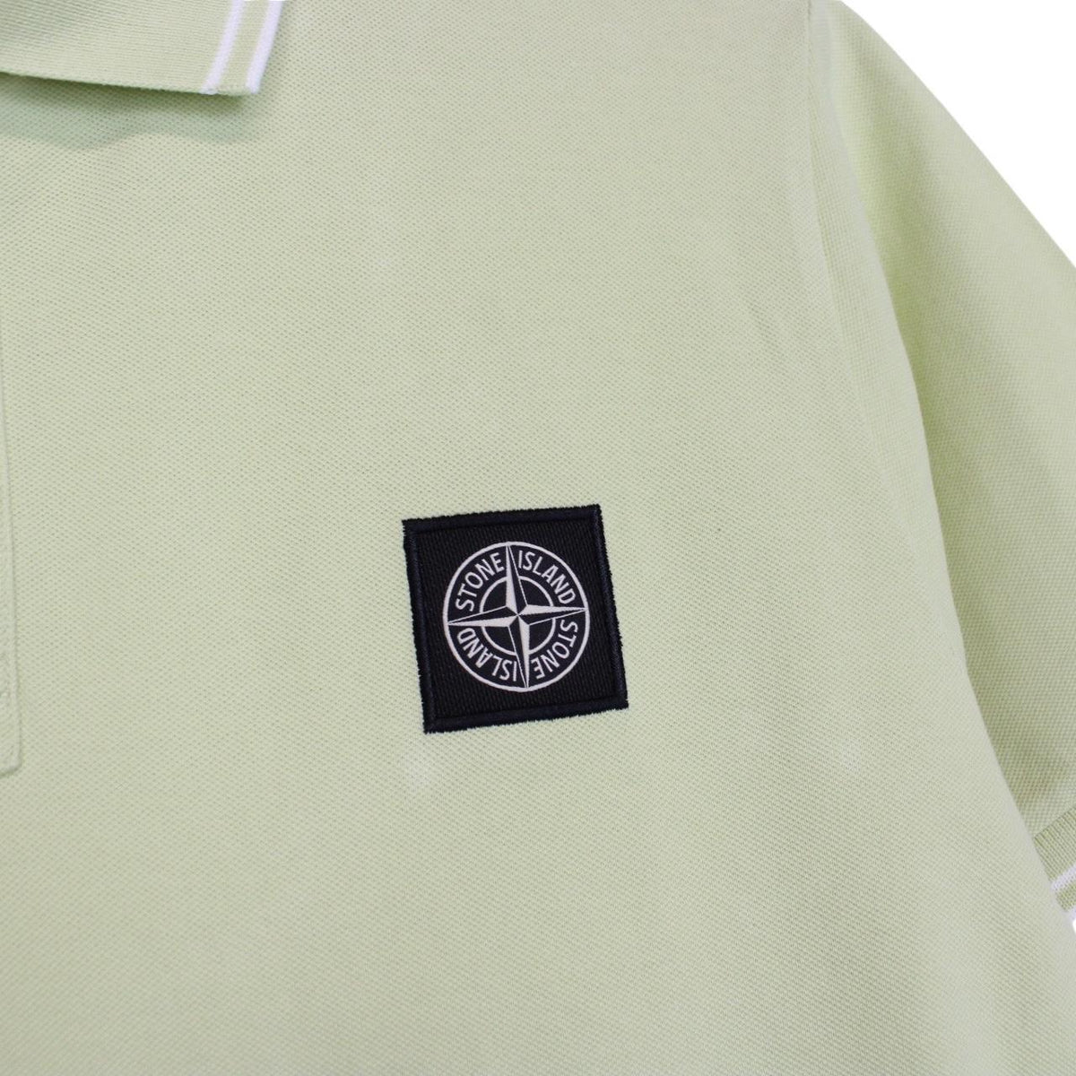Stone Island green polo shirt with compass logo, cotton material, short sleeves.