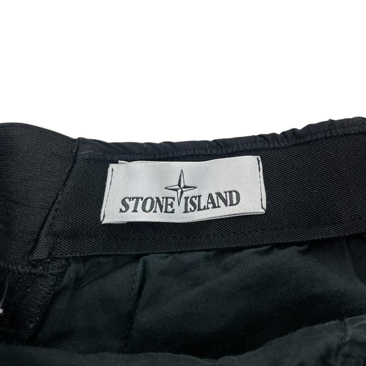 Stone Island navy blue joggers with logo patch and nylon material.
