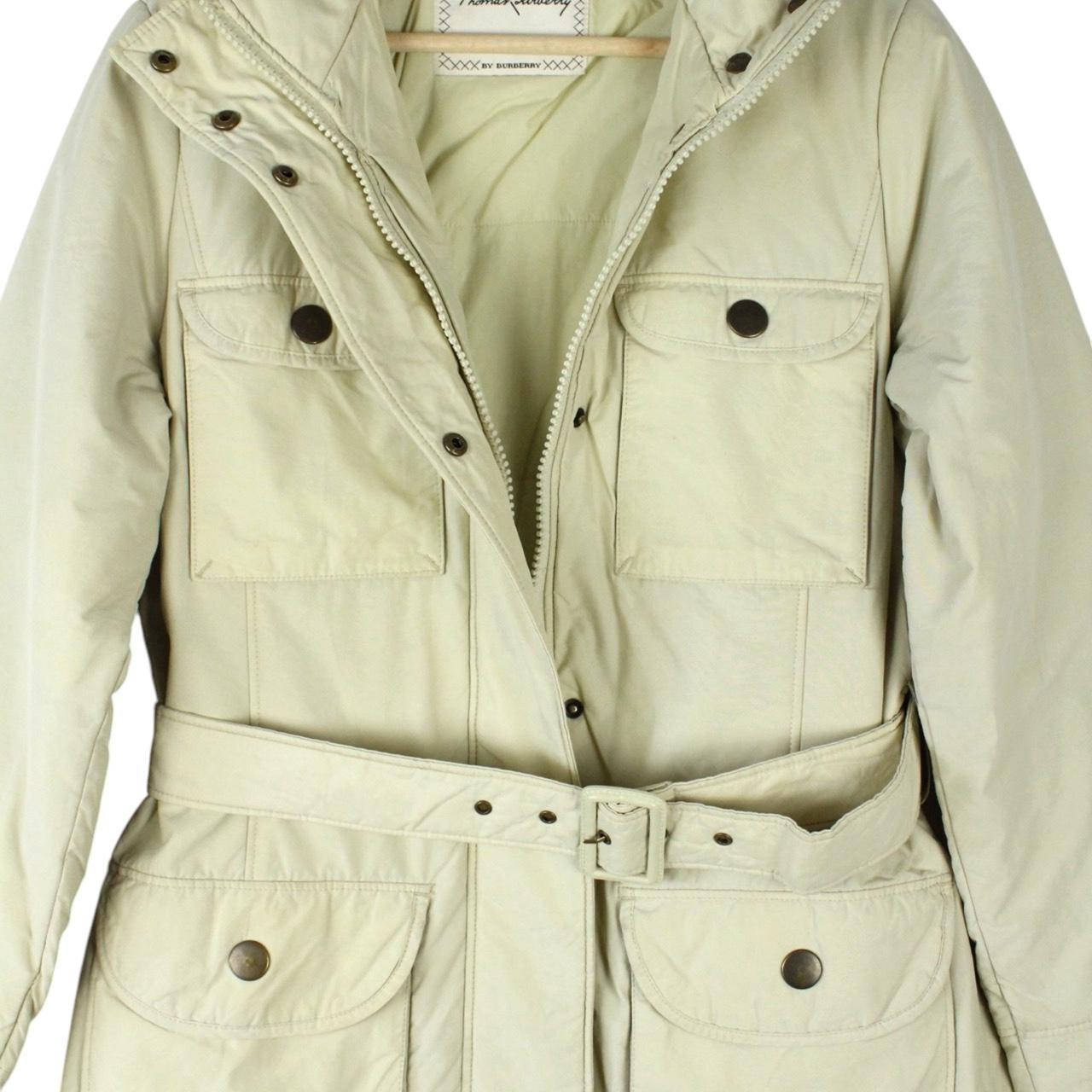 Burberry cream belted down jacket with classic logo and quilted texture.