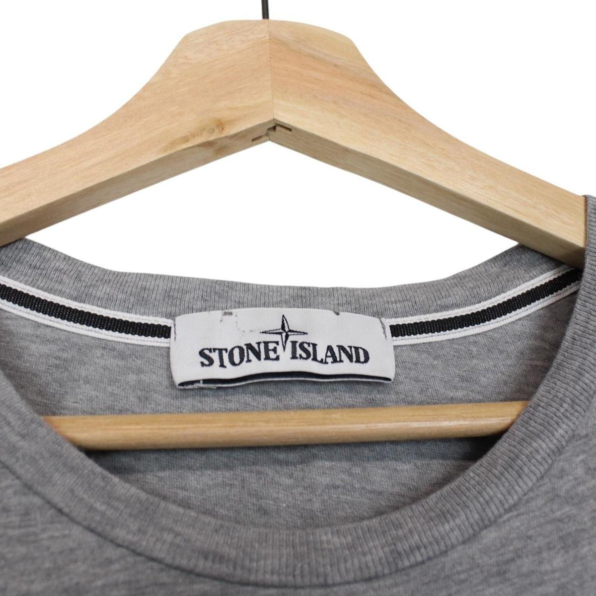 Stone Island grey short sleeve cotton t-shirt with logo print and visible stains.