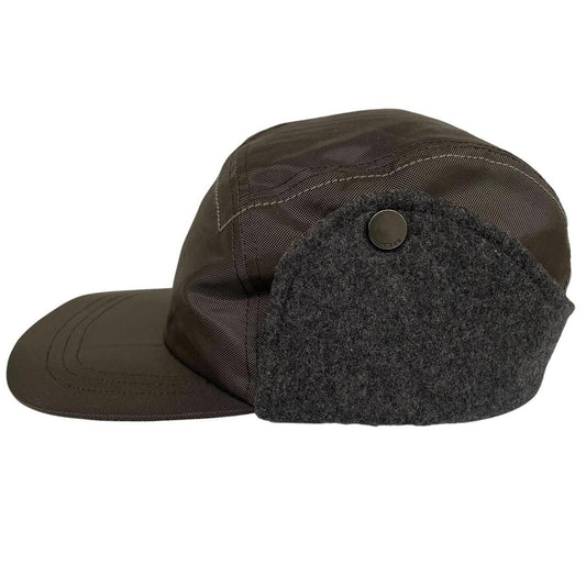 Paul Smith khaki green nylon ear-flap cap with logo detail and adjustable straps.