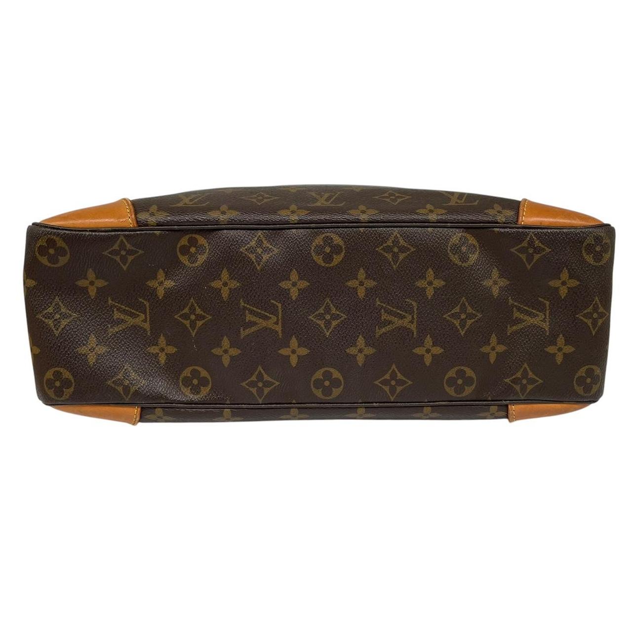Louis Vuitton brown and tan monogram canvas duffel bag with leather accents and logo.