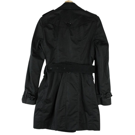 Burberry black double breasted belted trench coat with logo detailing and classic design.