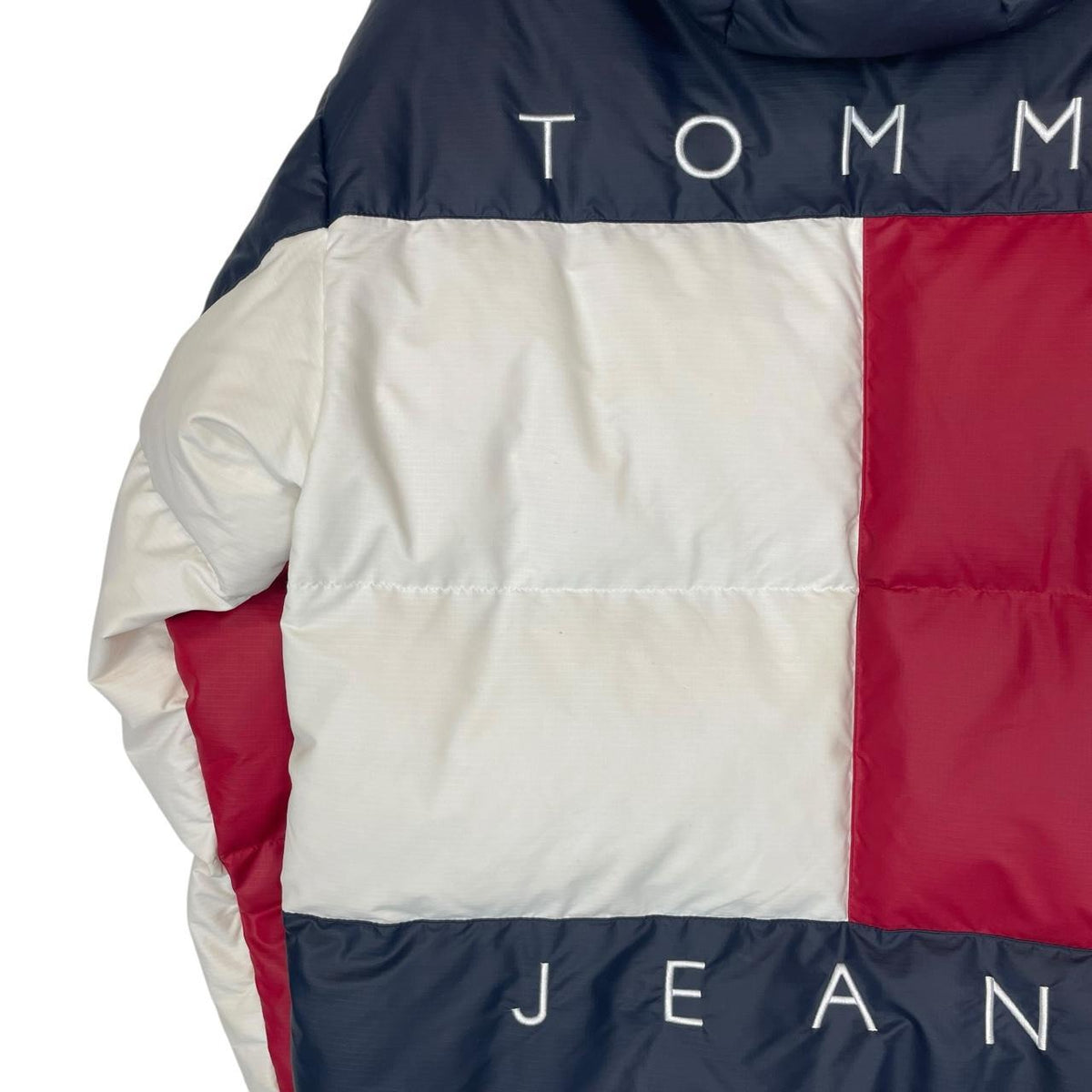 Tommy Hilfiger navy blue pullover jacket with 1/4 zip and hood, nylon material.