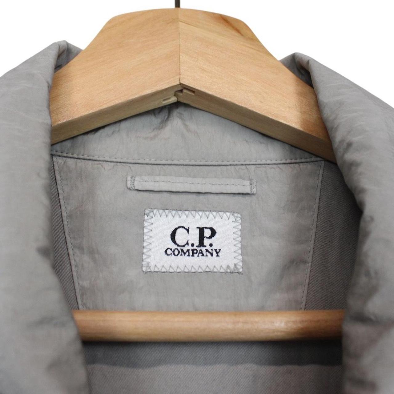 CP Company grey overshirt jacket with lens detail and garment dyed nylon fabric.