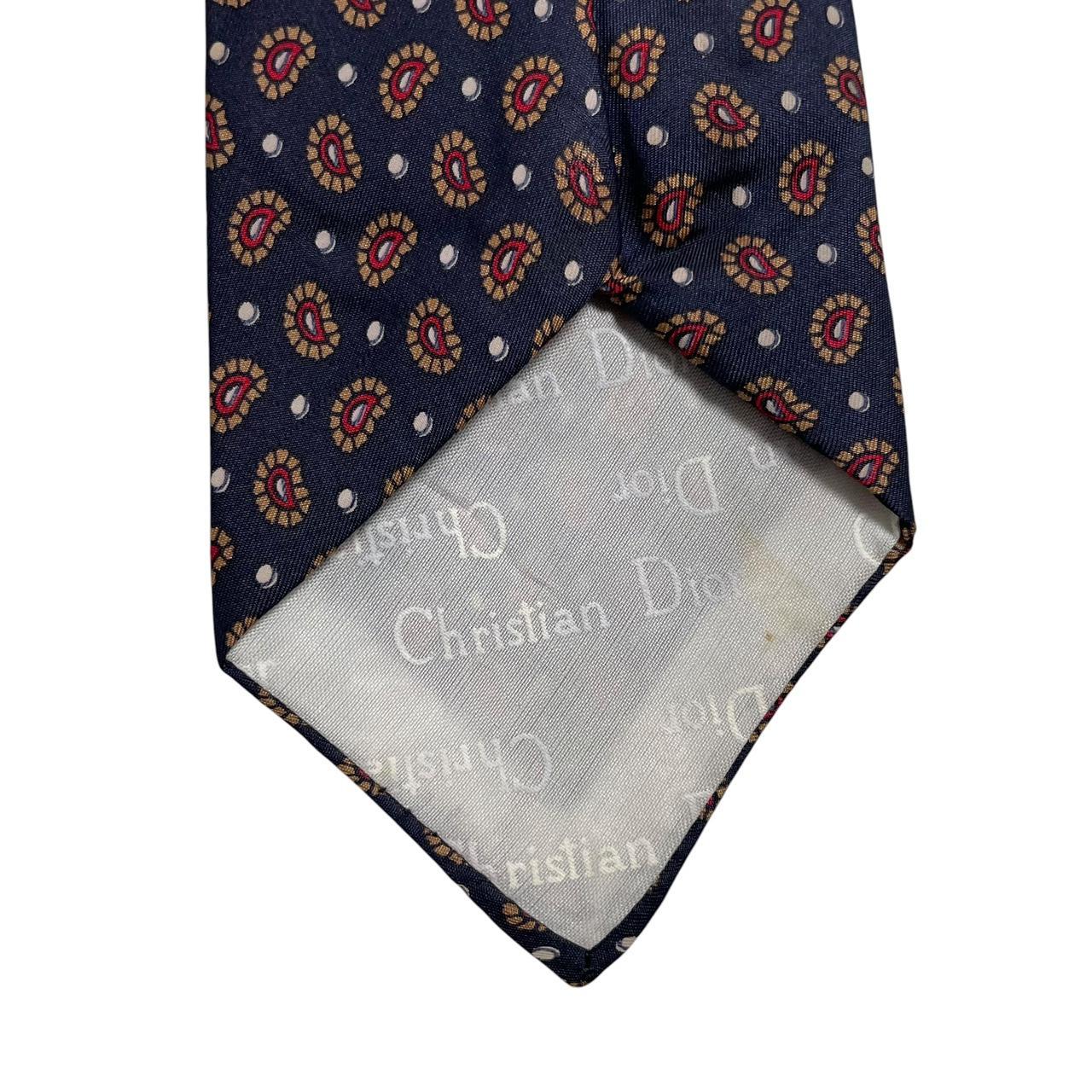 Christian Dior navy blue silk tie with paisley print pattern and logo detail.