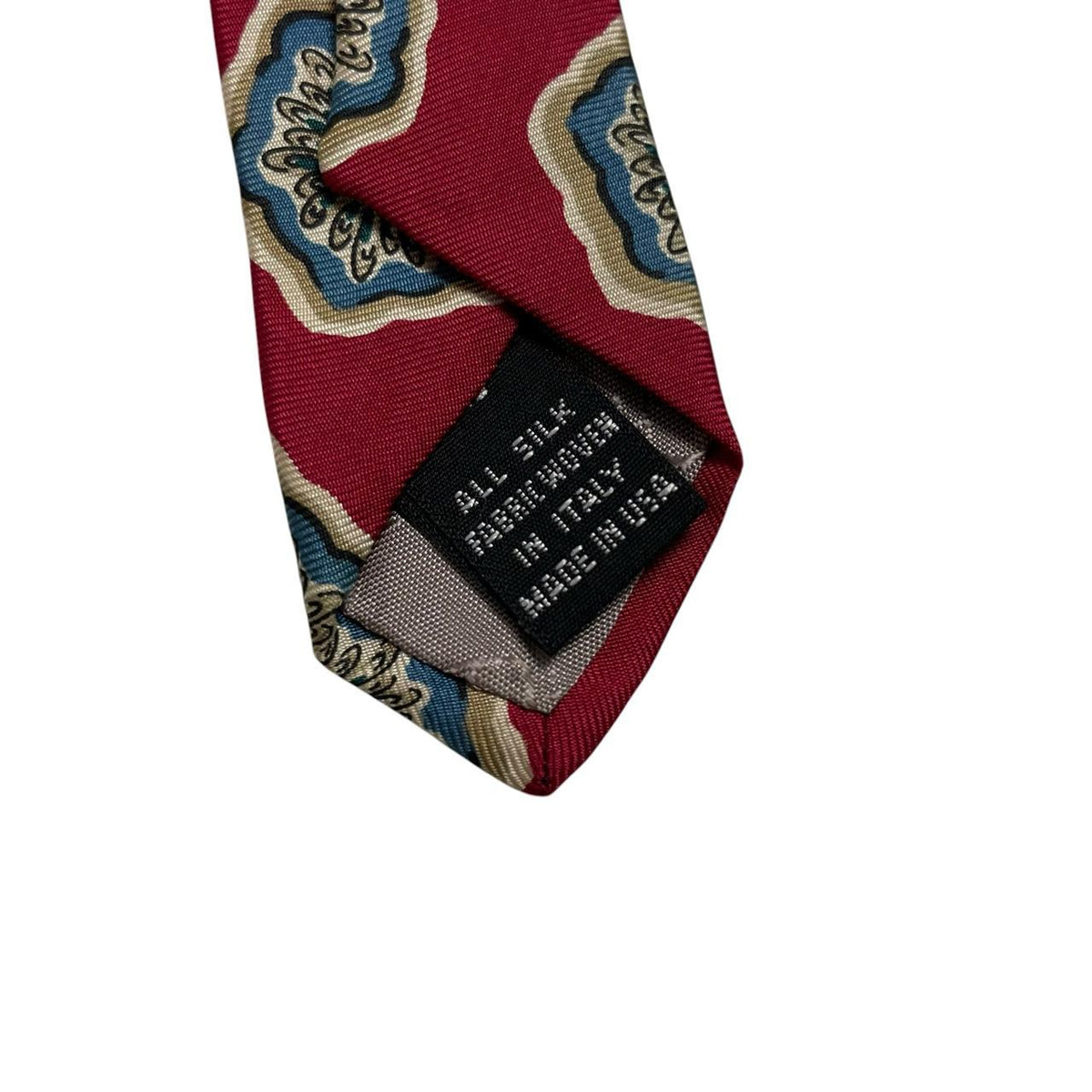 Christian Dior red silk tie with geometric pattern and logo detail.