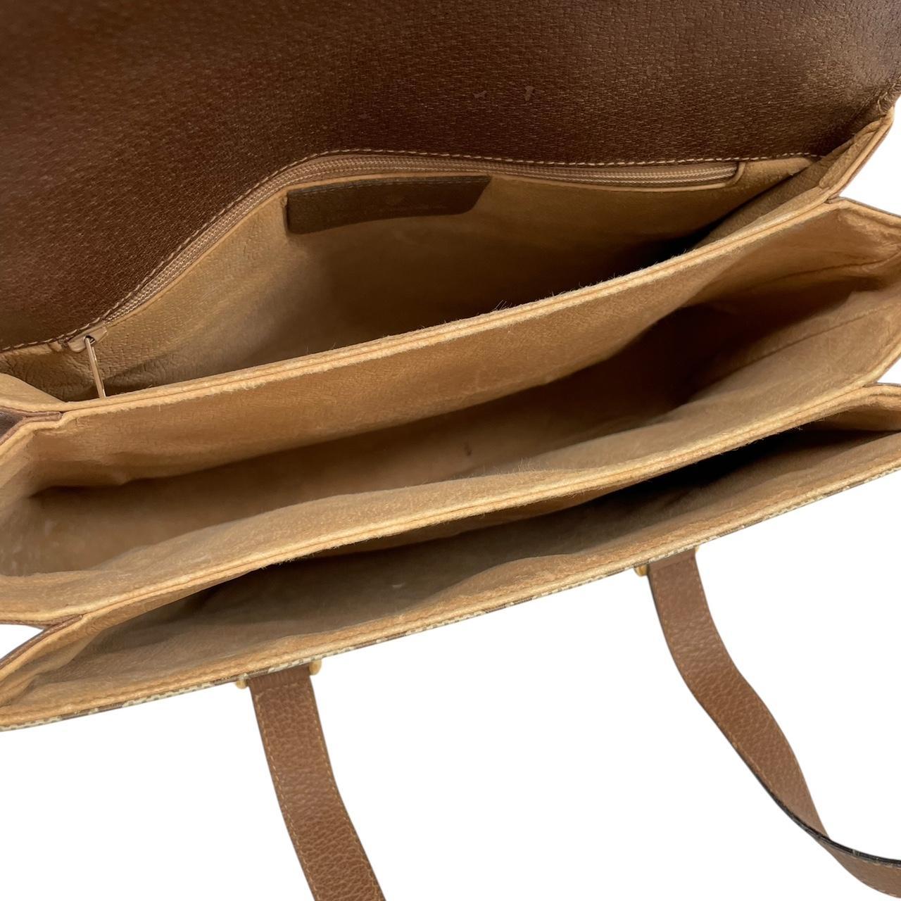 Gucci brown duffel bag with monogram canvas and top handle design.