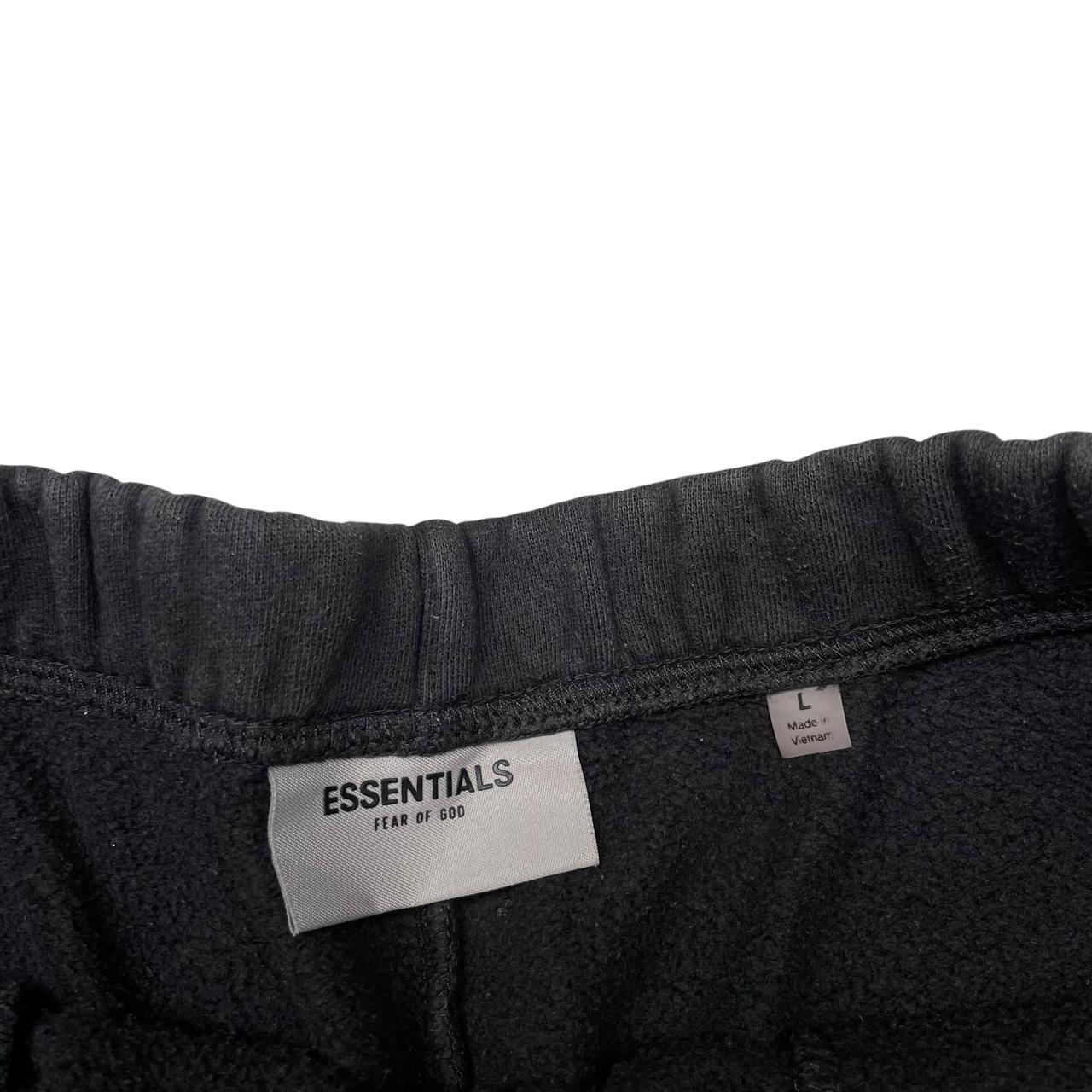 Essentials black jogger shorts cotton material with faded detailing and logo.