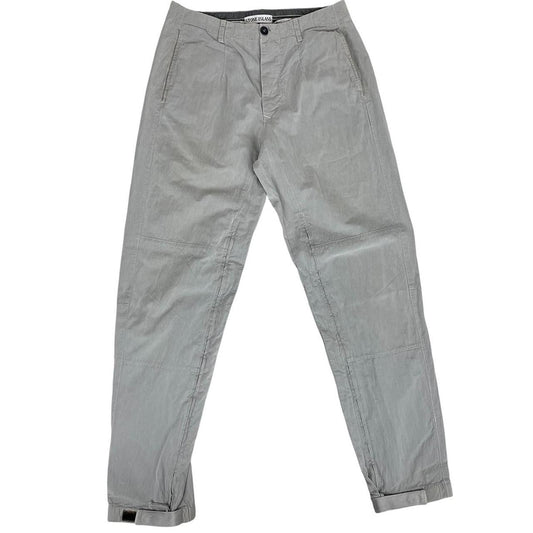 Stone Island grey tapered fit trousers with logo patch and cotton material.