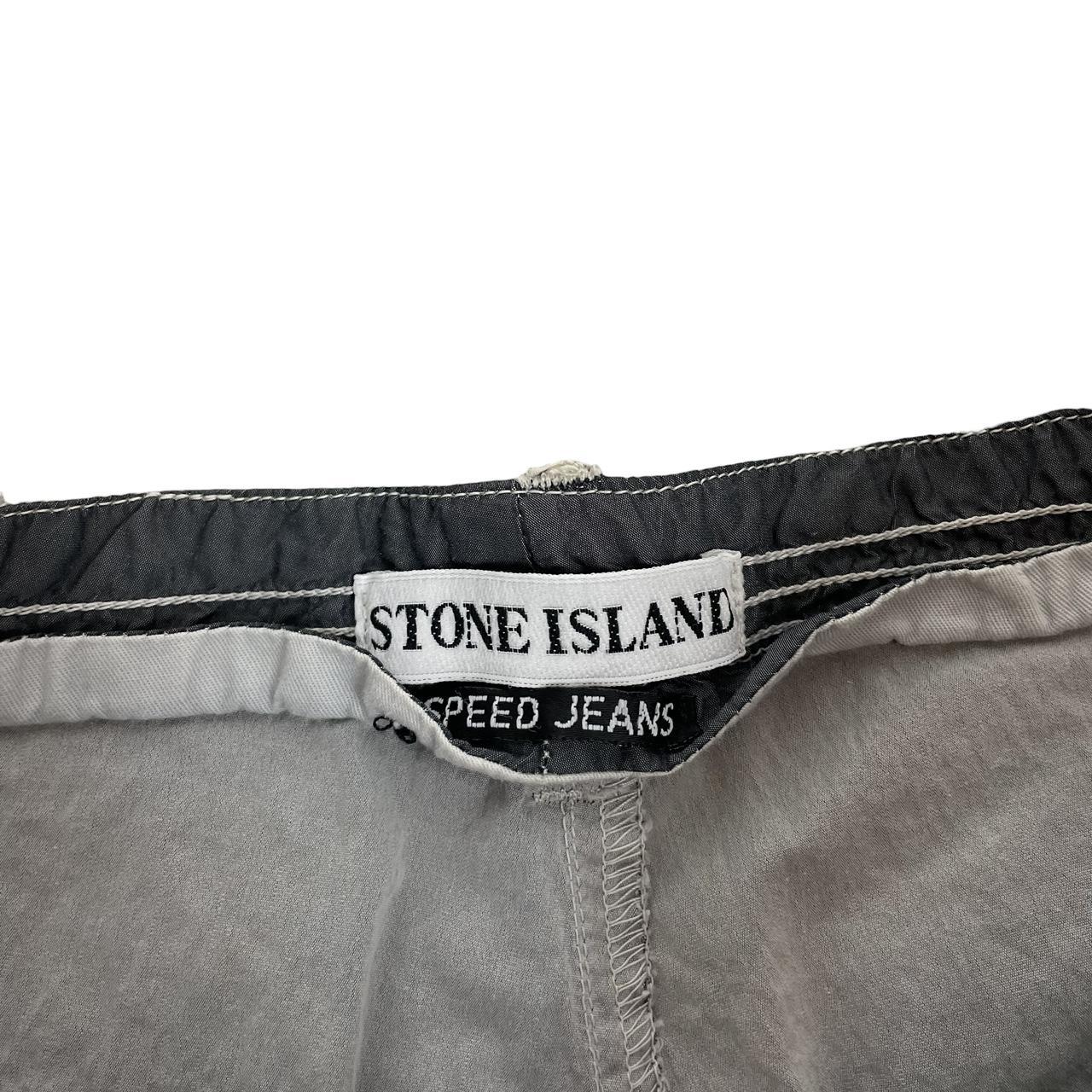 Stone Island grey tapered fit trousers with logo patch and cotton material.