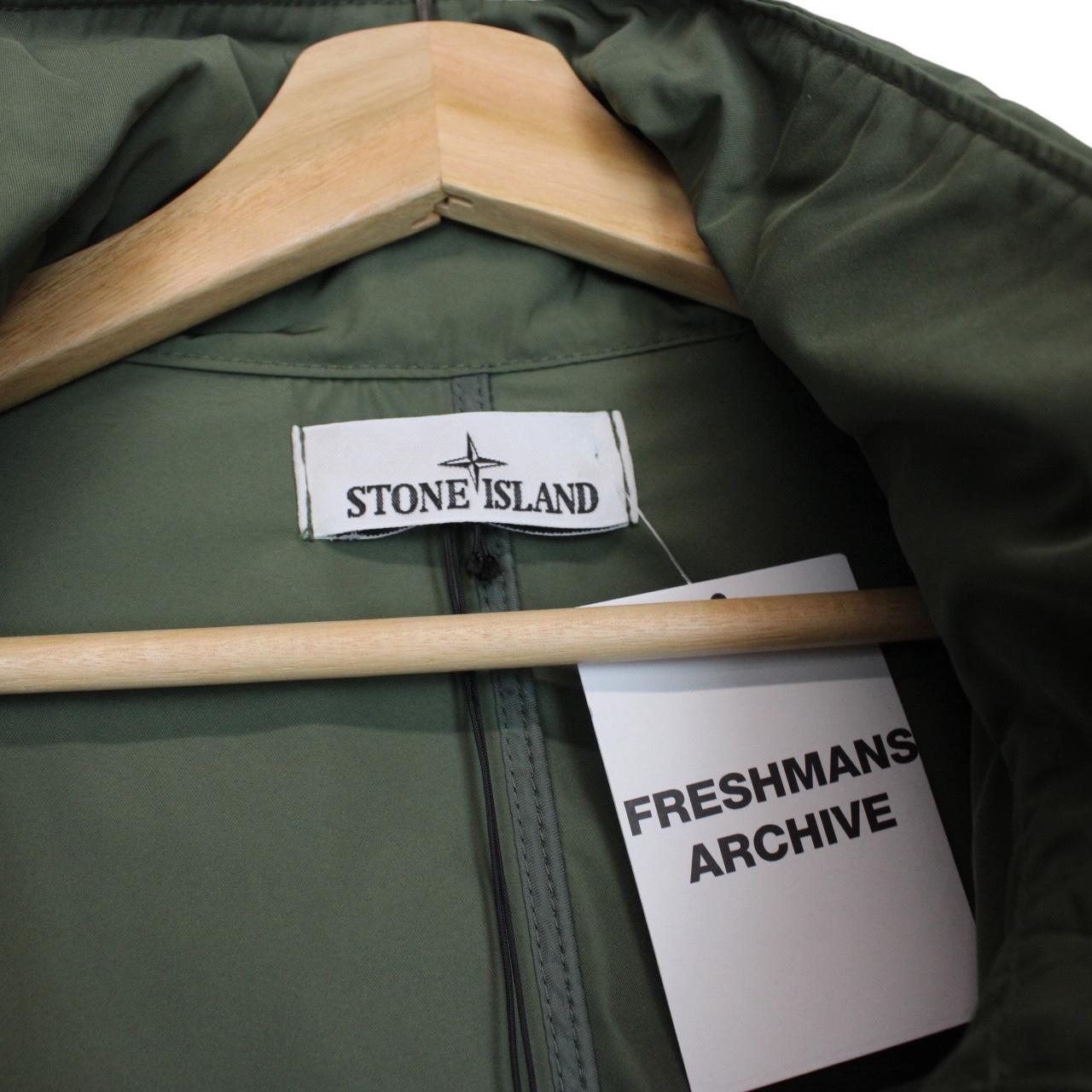 Stone Island green full zip jacket with packable hood and removable brand patch.