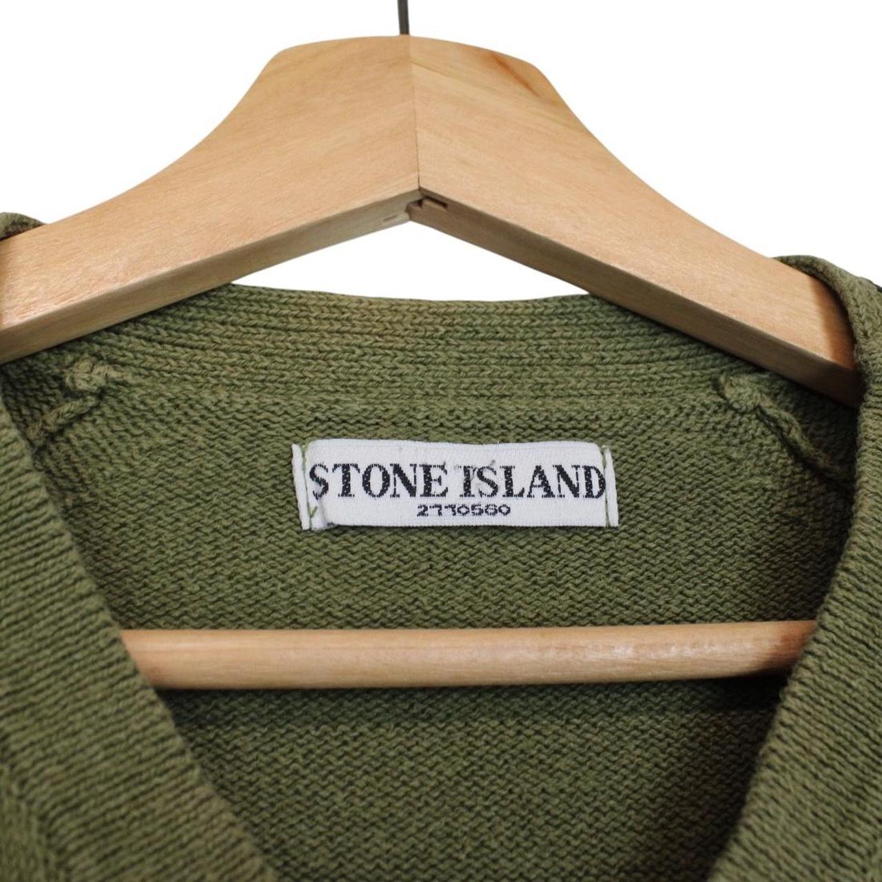 Stone Island green v-neck cotton knit jumper with logo patch and visible wear.