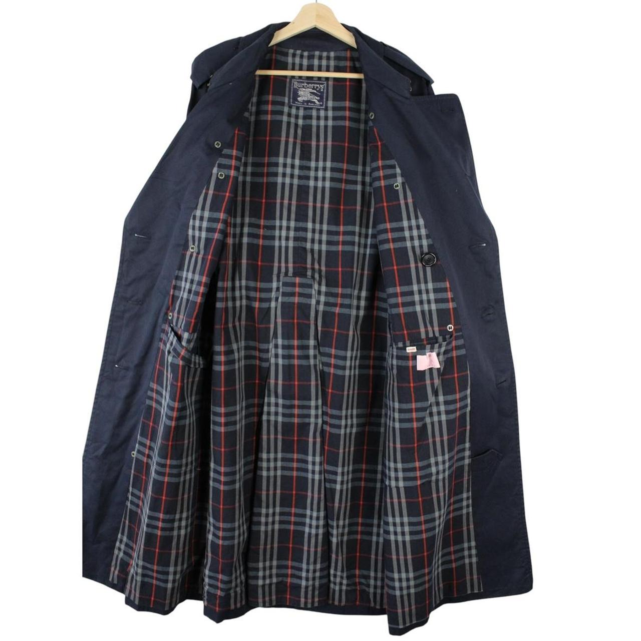 Burberry navy blue belted double breasted trench coat with classic check lining.