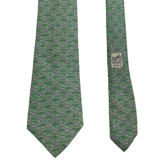 Hermes green silk tie featuring zebra print design and logo detail.