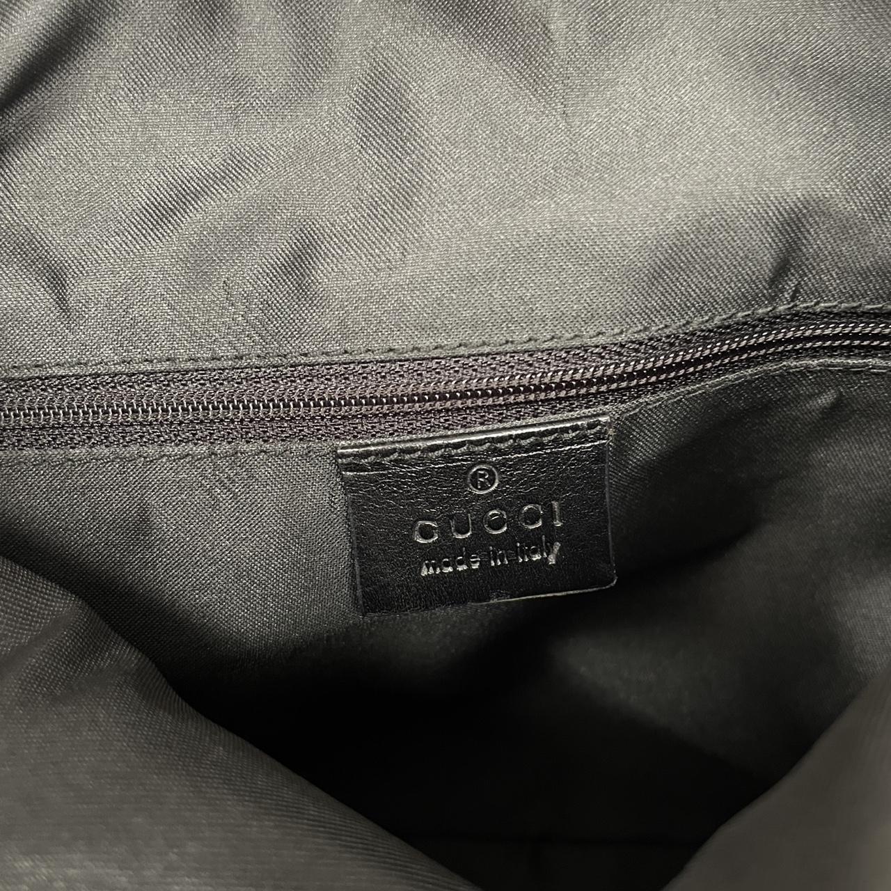 Gucci black hobo shoulder bag with monogram canvas and leather detailing.