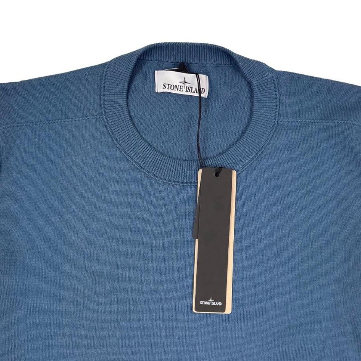 Stone Island blue organic cotton knit jumper with logo patch and ribbed cuffs.