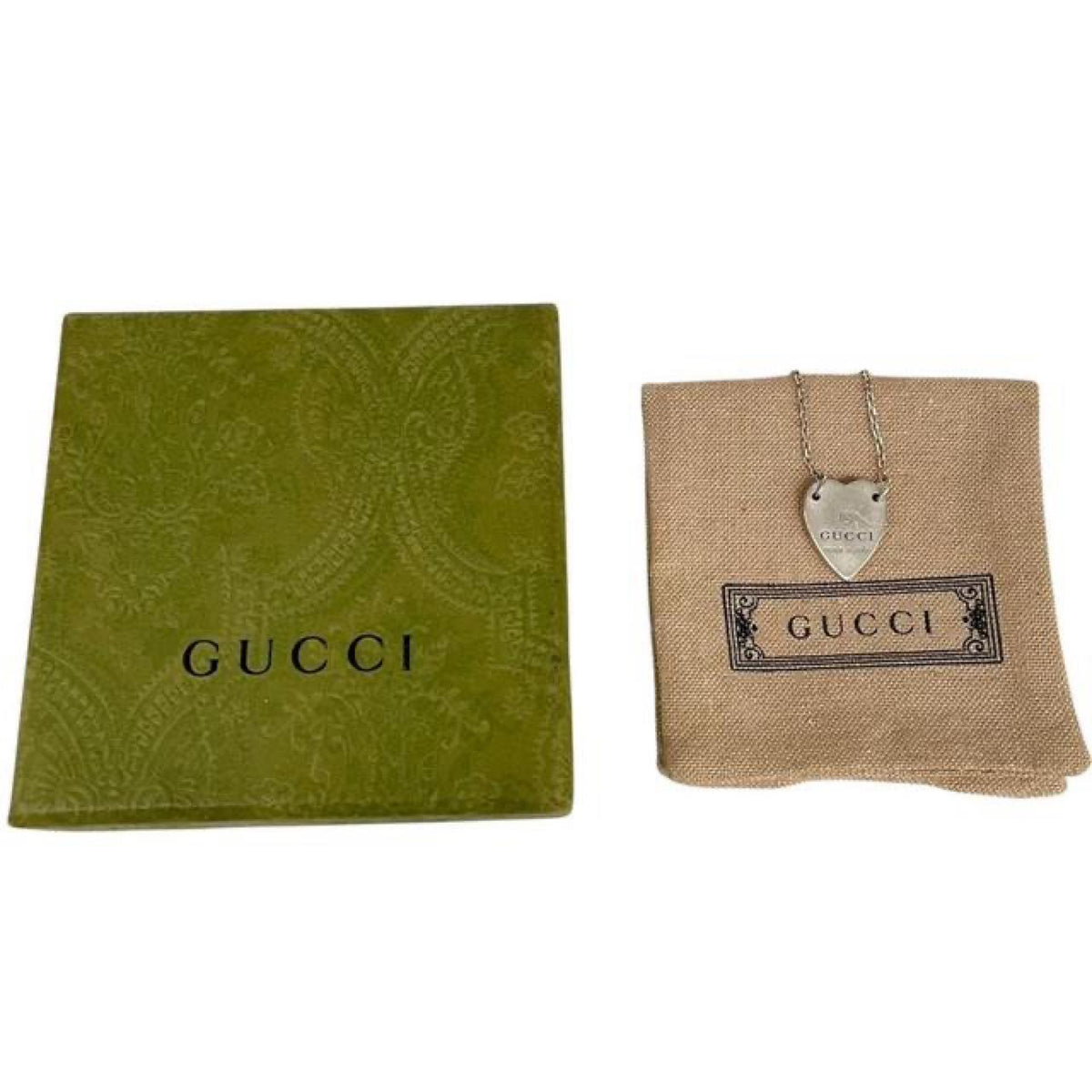 Gucci silver necklace with trademark heart pendant and minor scratches.