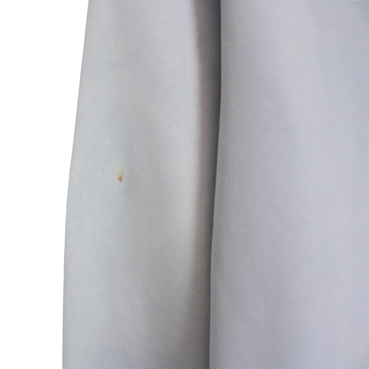 Stone Island blue cotton sweatshirt with logo patch and faded left sleeve.