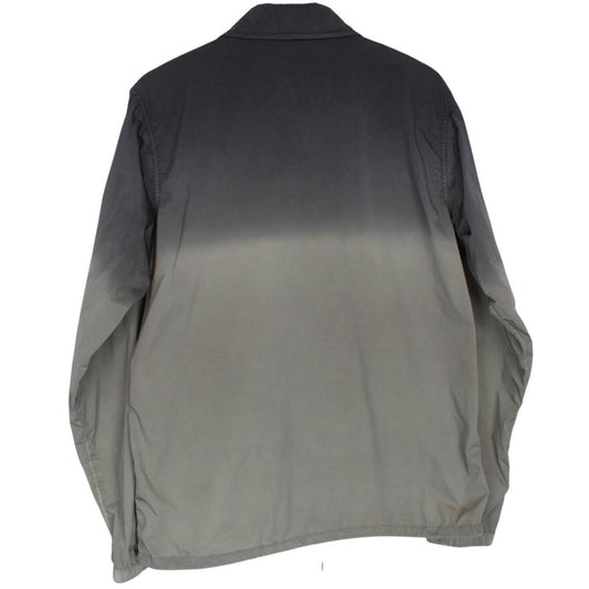 CP Company khaki green and grey jacket with shibori pattern and lens detail.