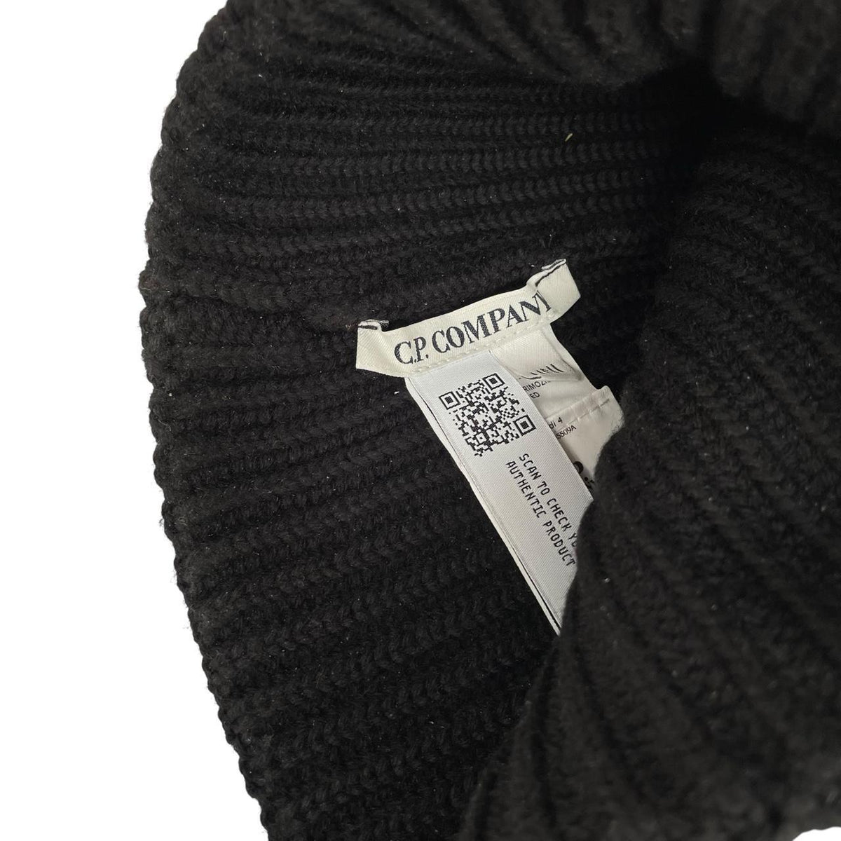 CP Company black wool knit beanie hat with signature lens detail.