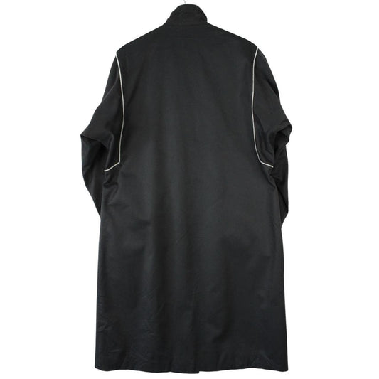 Burberry black cotton trench coat with single breasted design and classic logo detailing.