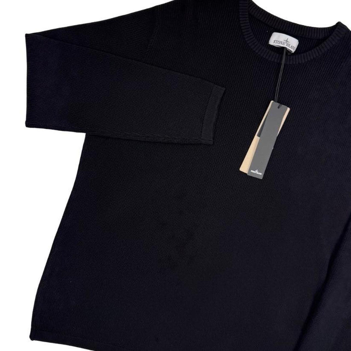 Stone Island black ribbed knit jumper with logo badge and organic cotton material.