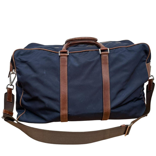 Prada navy blue and brown nylon duffel bag with signature logo and minimal wear.