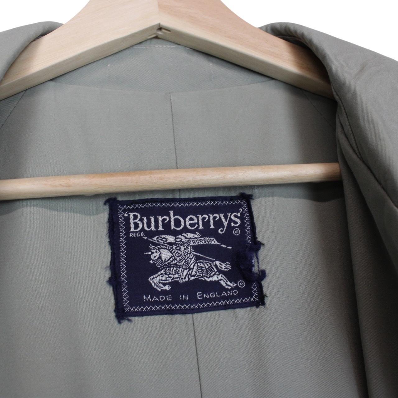 Burberry green trench coat with Nova Check pattern and single-breasted design.