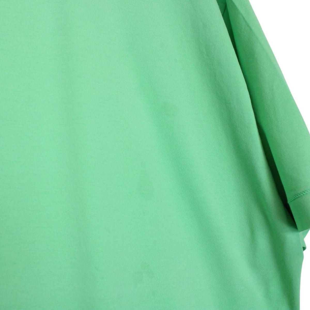 Stone Island green short sleeve cotton t-shirt with compass logo and tag detail.