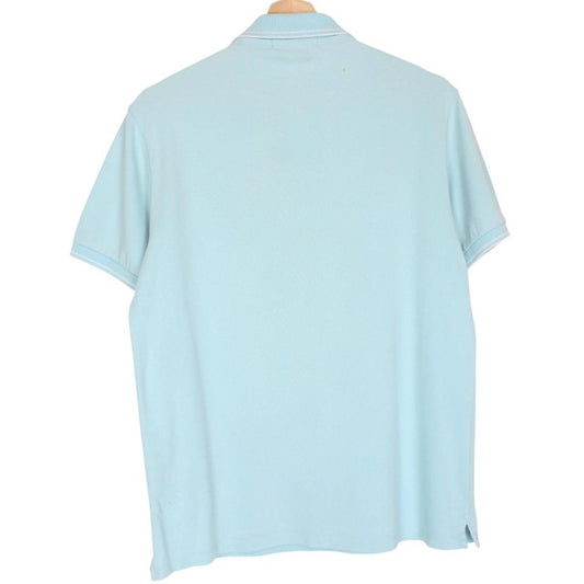 Stone Island blue polo shirt with embroidered compass logo and slim fit cotton material.