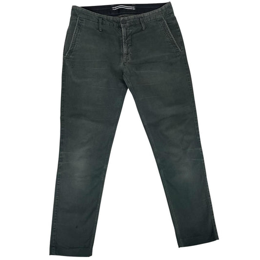 Stone Island green slim fit cotton trousers with logo patch and faded details.