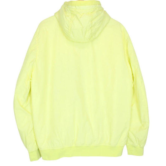 Stone Island yellow jacket with crinkle texture and logo badge on sleeve.